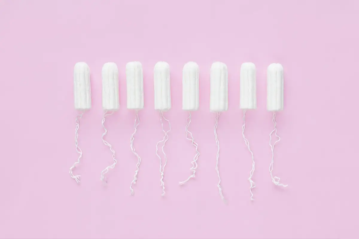 Menstrual period concept. Woman hygiene protection. Cotton tampons on pink background.
