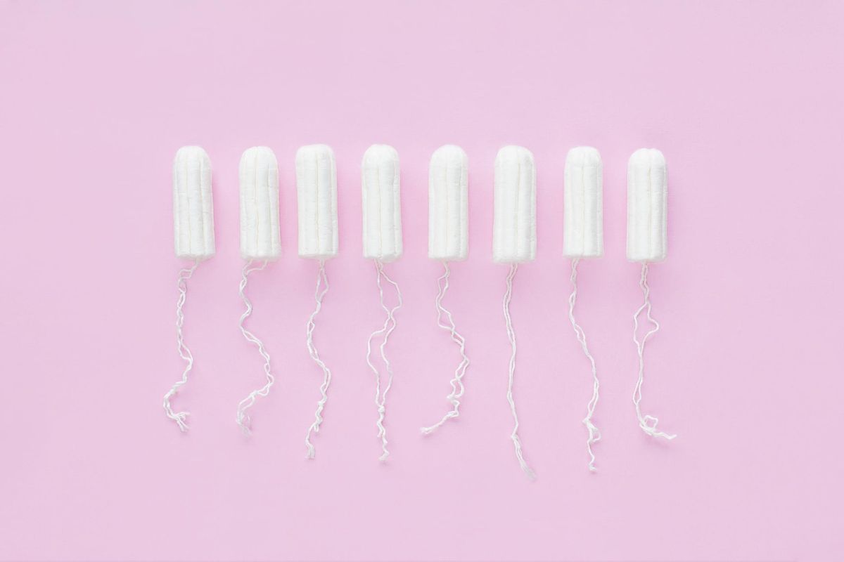 Menstrual period concept. Woman hygiene protection. Cotton tampons on pink background.
