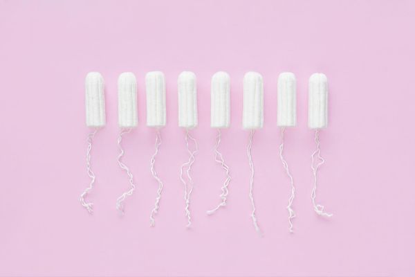 Menstrual period concept. Woman hygiene protection. Cotton tampons on pink background.