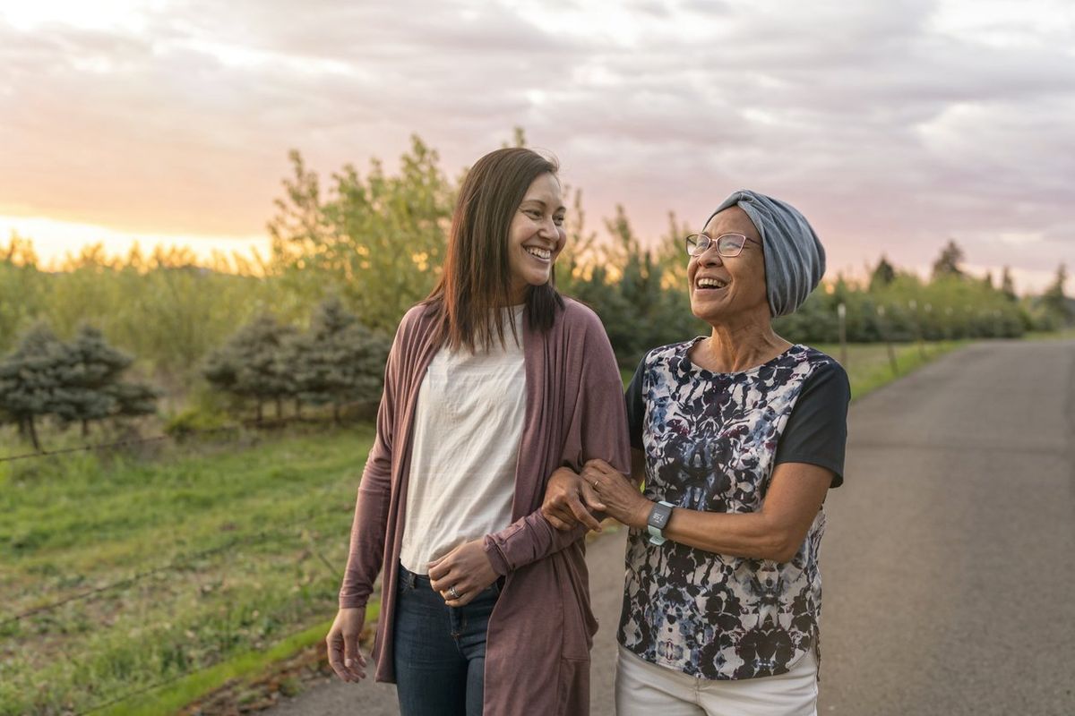 mixed race mother and daughter relaxing outdoors together