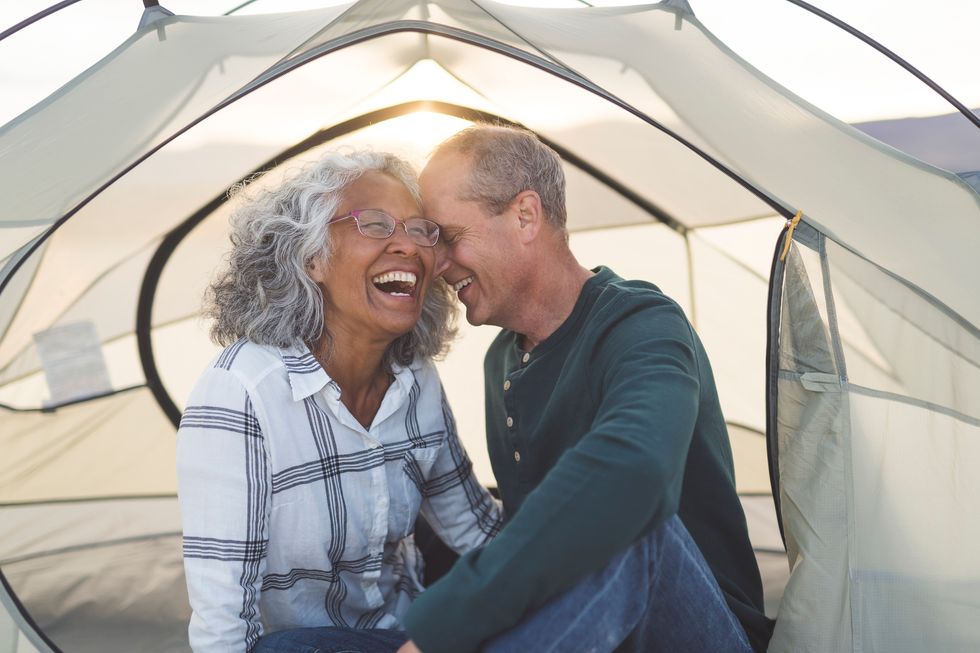 mixed race senior couple snuggle and flirt