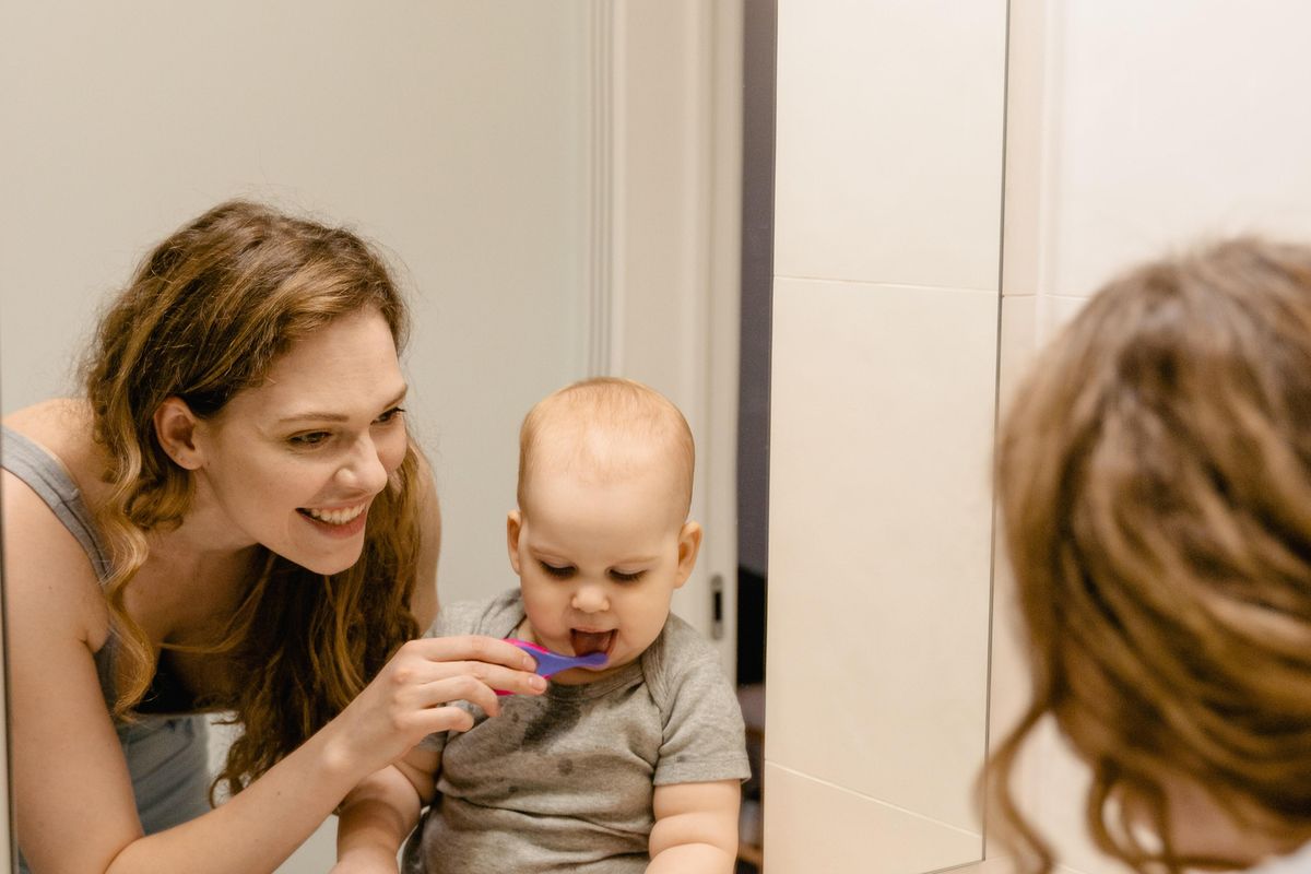 mom and baby brushing teeth