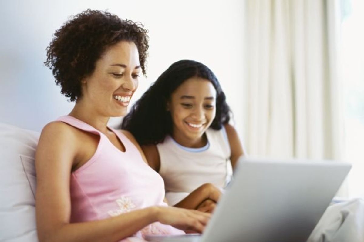 mom and daughter looking at a laptop