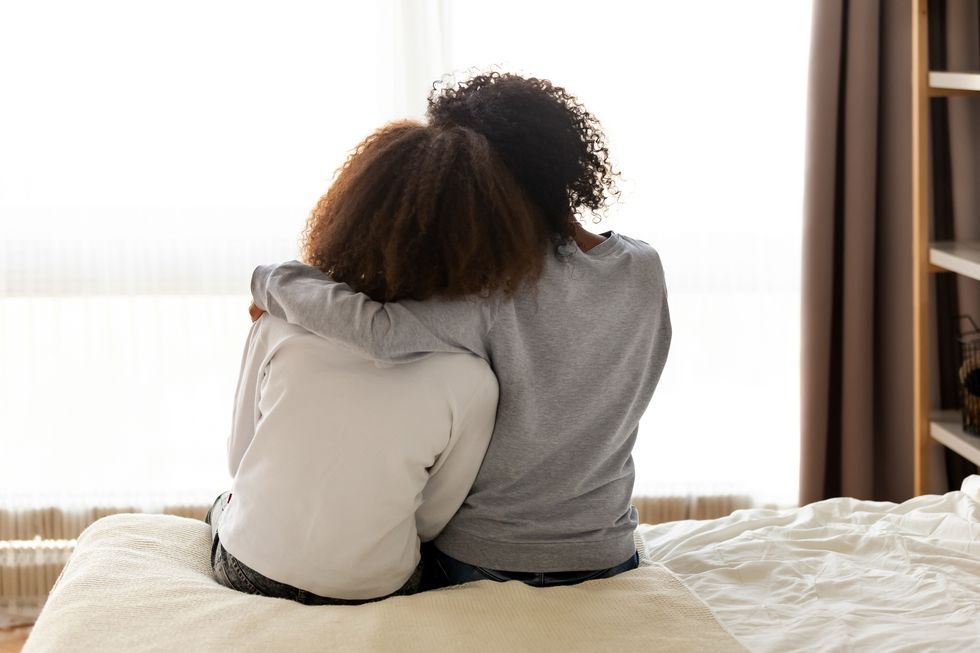 mom hugging daughter
