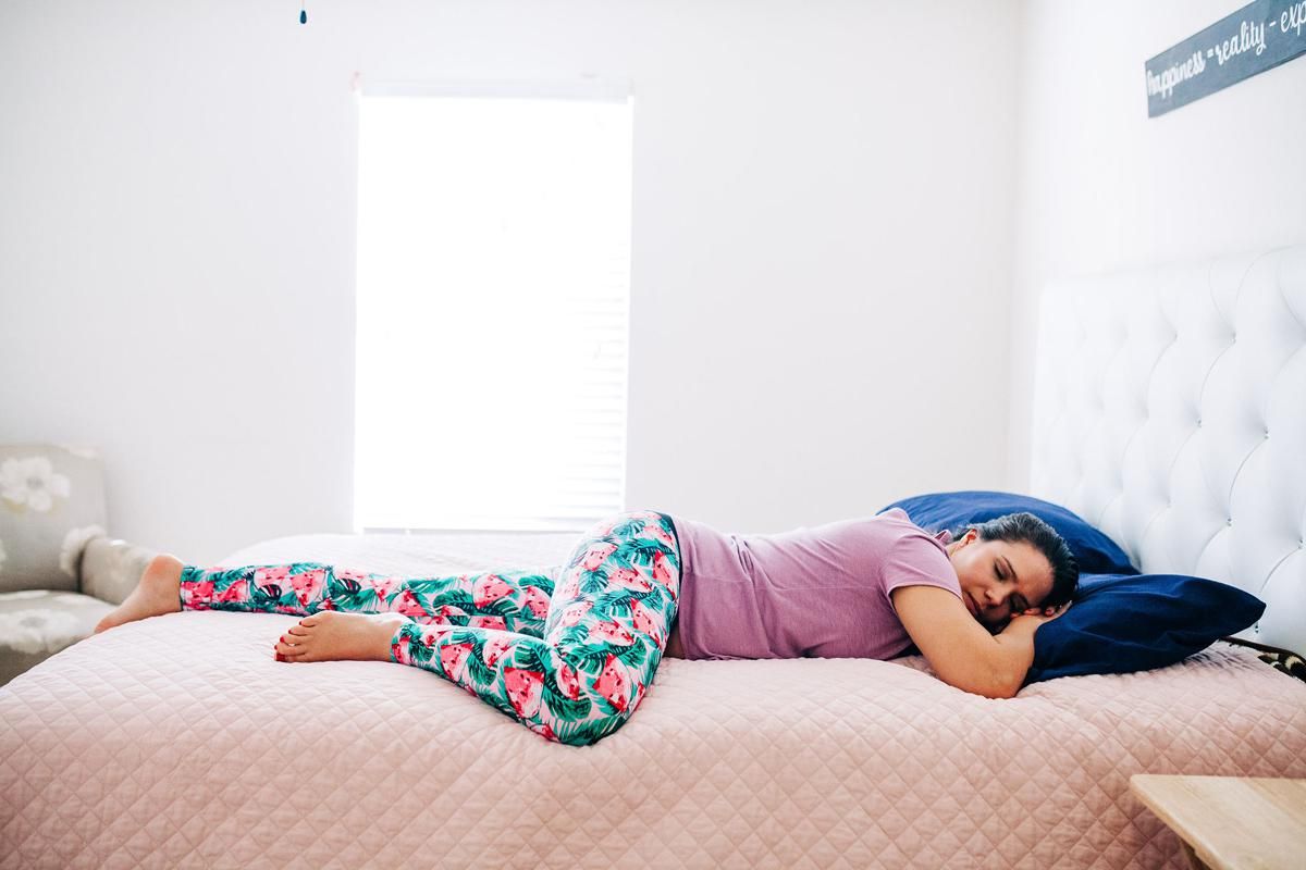 Monica laying on her bed