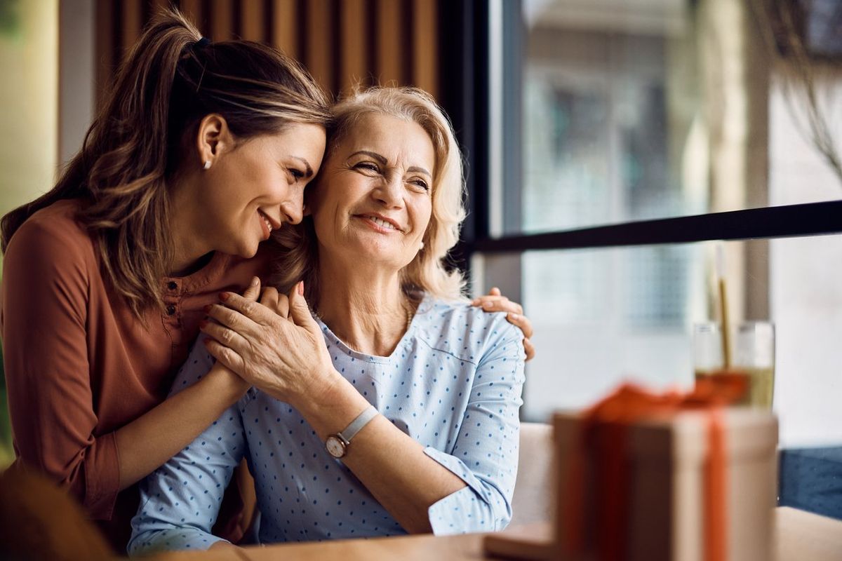 mother and adult daughter hugging