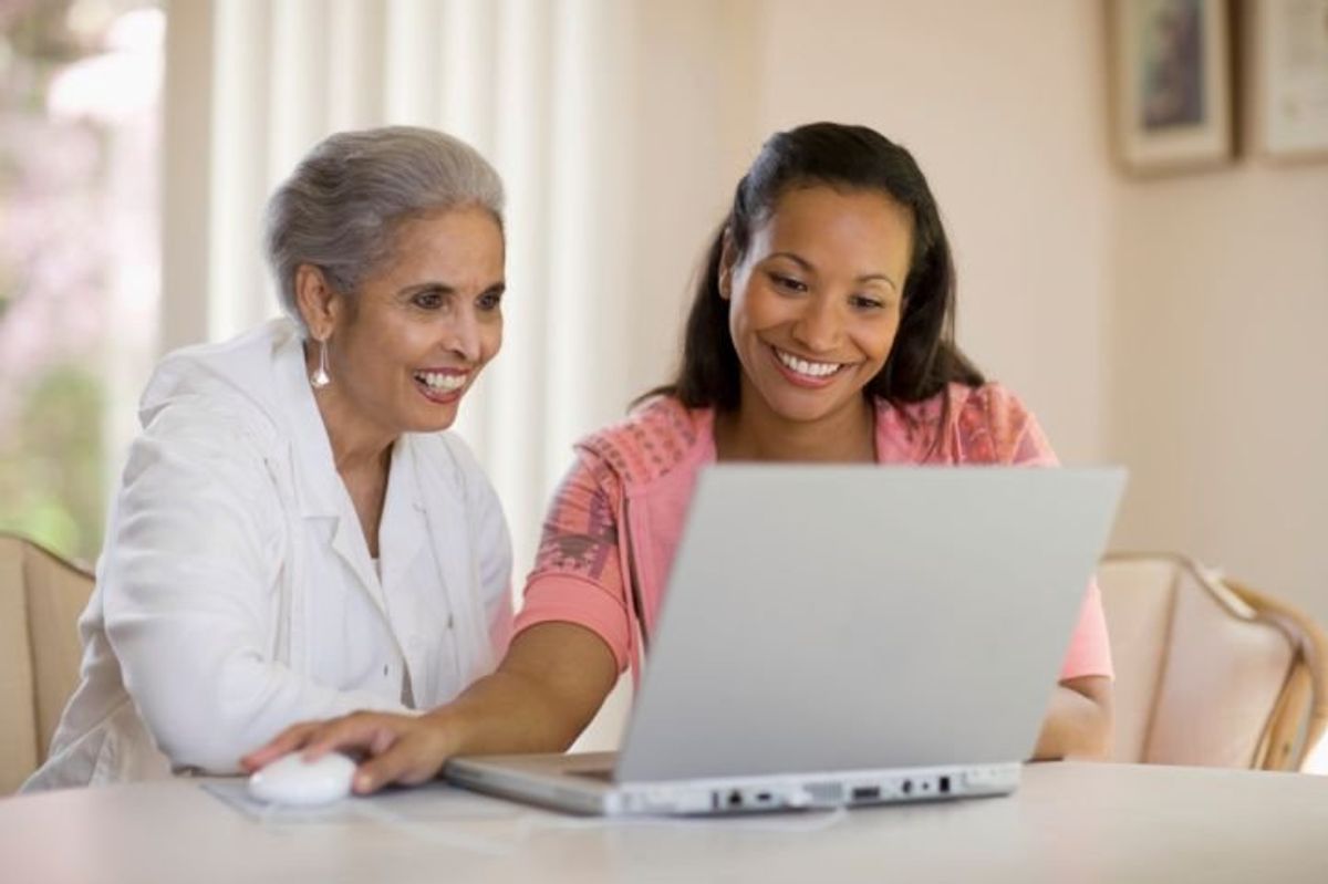 mother and daughter looking at a laptop together
