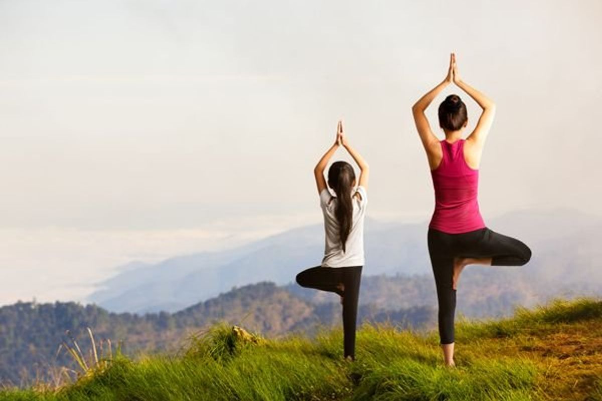 mother and daughter practicing yoga