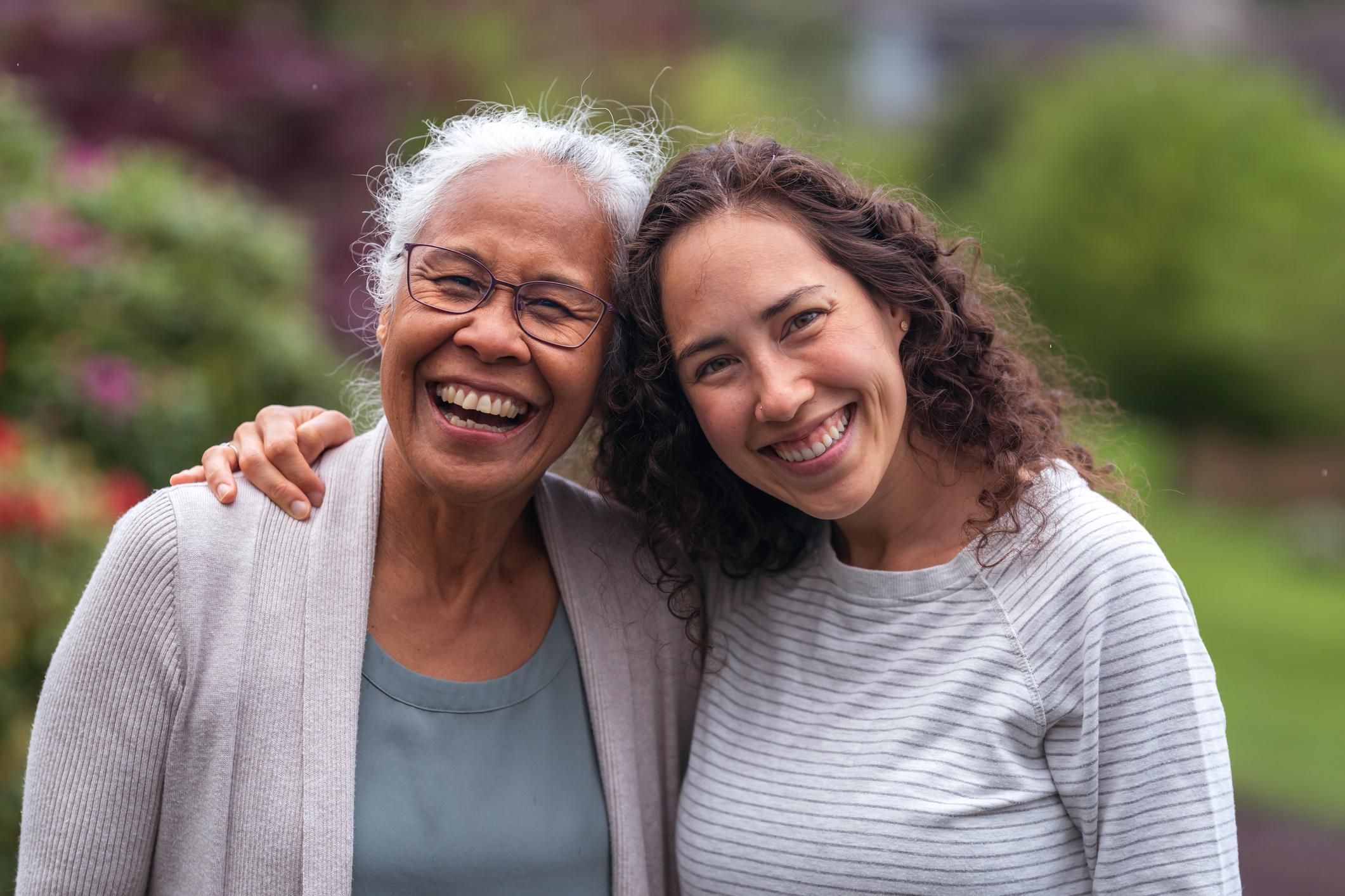 mother and daughter walk and talk together outside