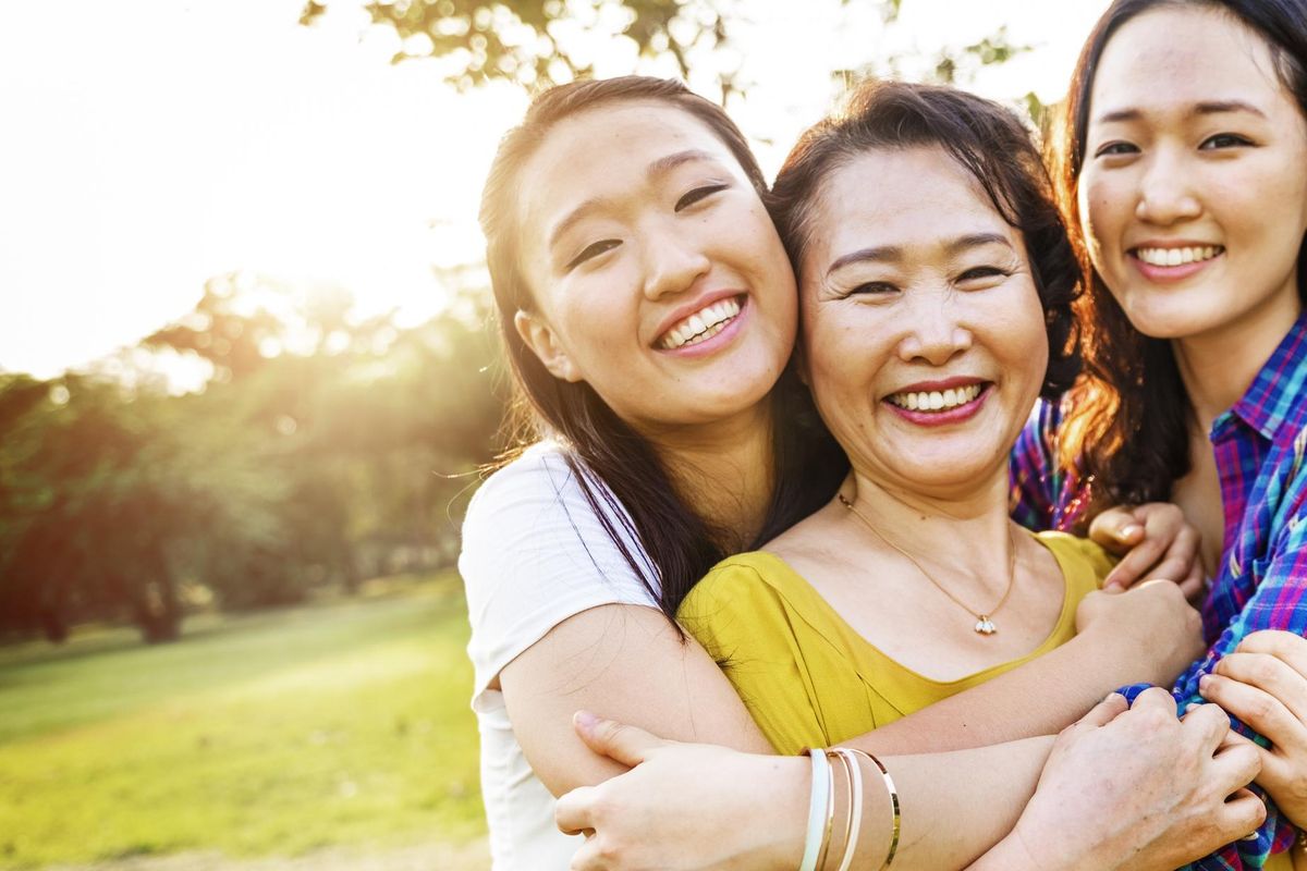 mother and daughters hugging