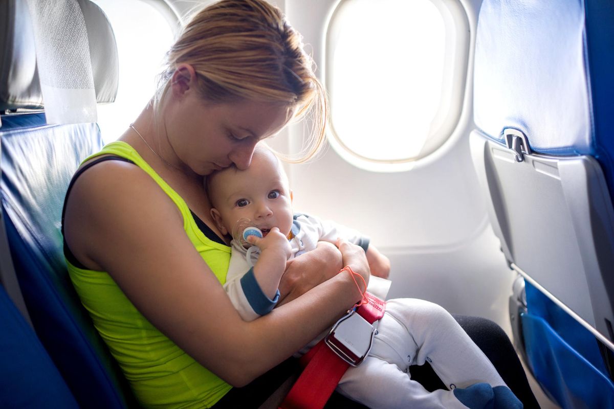 mother and her baby traveling by airplane