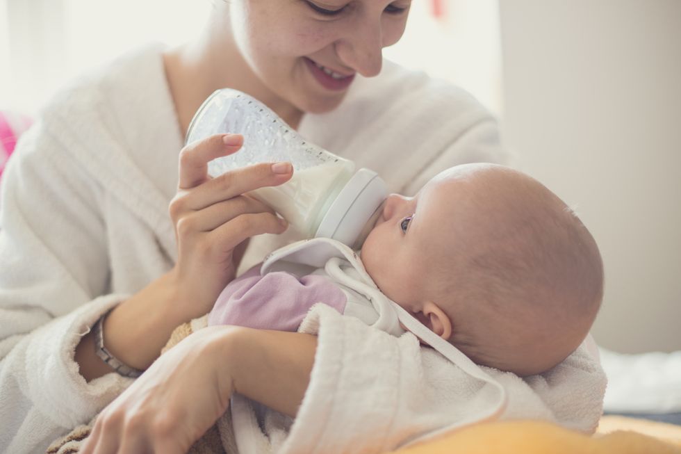 mother feeding baby with a bottle