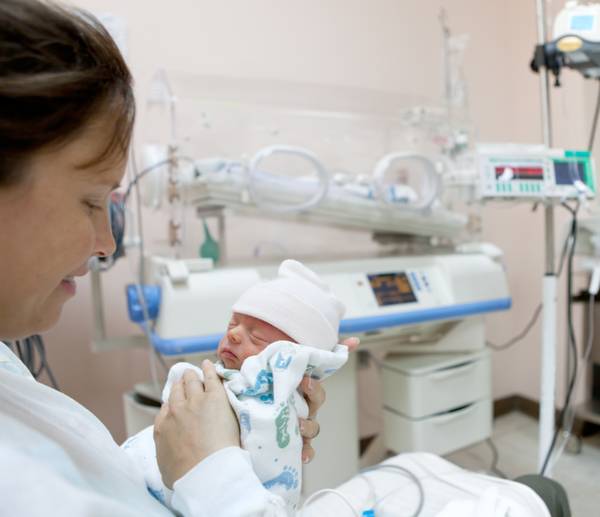 mother holding a premature baby at the Neonatal Intensive Care Unit at the hospital