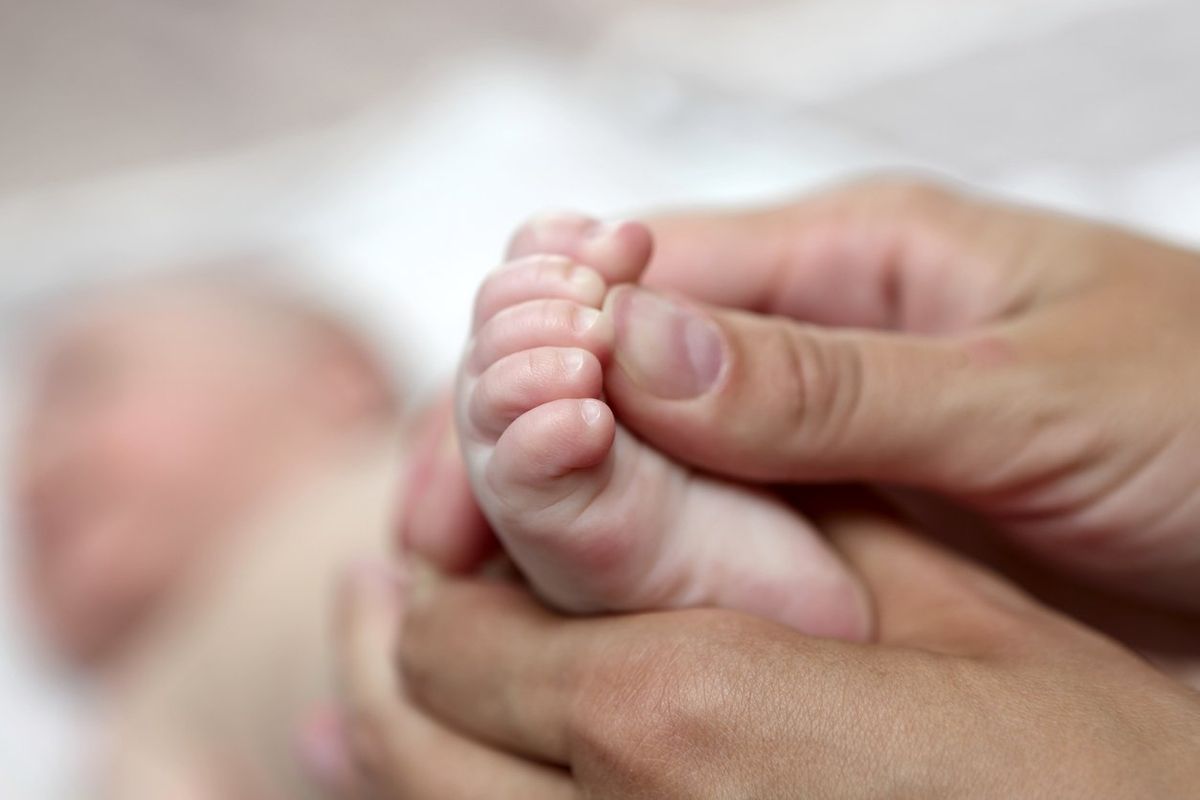 Mother massaging the baby foot