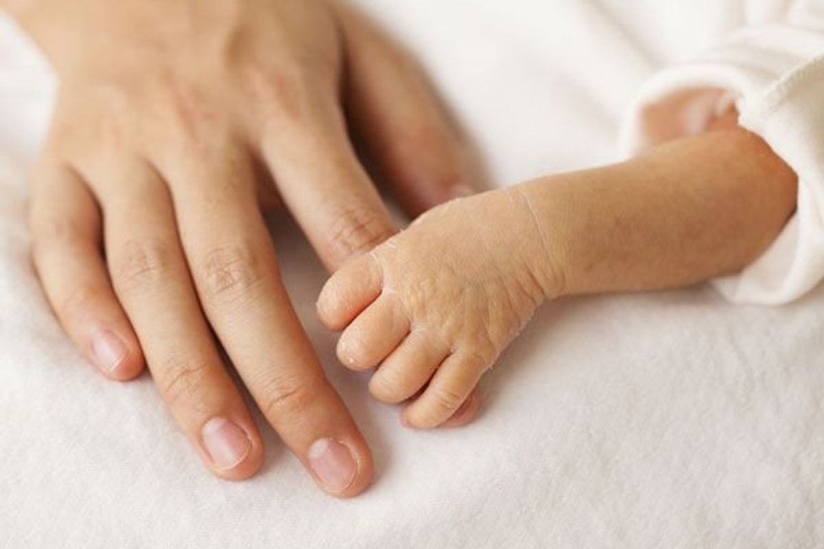mothers hand and infants hand