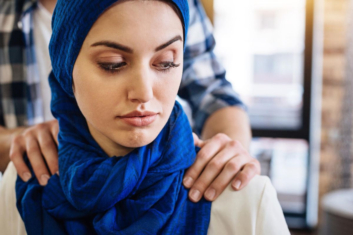 Muslim woman being harassed by representative of another group