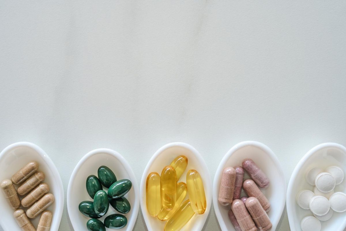 natural vitamin supplement on white spoon