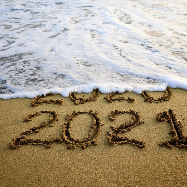 New year 2021 and 2020 on sandy beach with waves