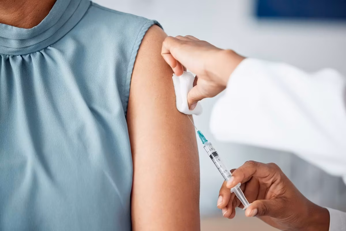 nurse doing a vaccination injection with a needle syringe