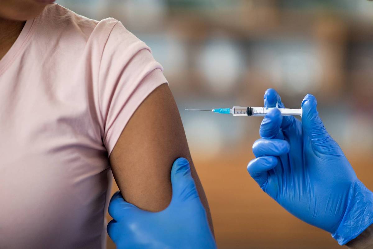 Nurse giving Biologics injection to woman patient for Treating Asthma