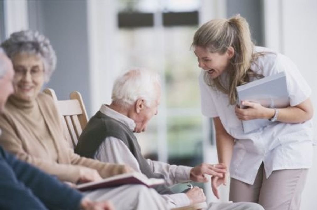 nurse talking with a man in a nursing home