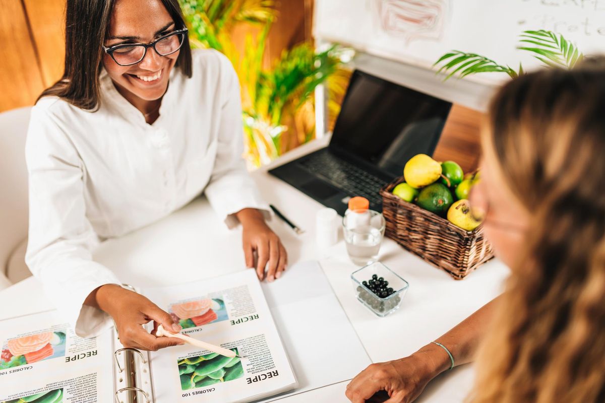 Nutritionist and Client Discussing Balanced Nutrition