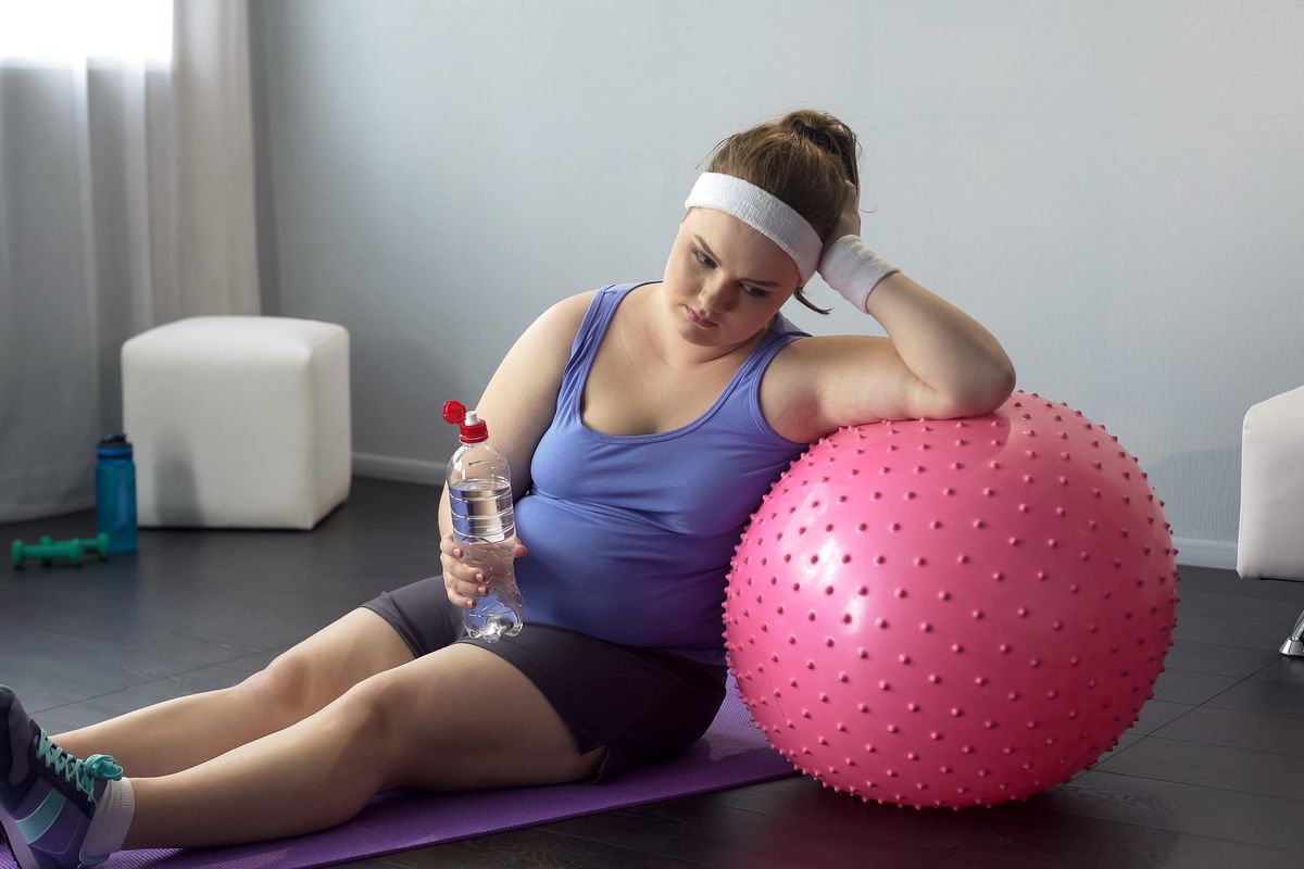 obese lady depressed about her weight unsuccessful workout