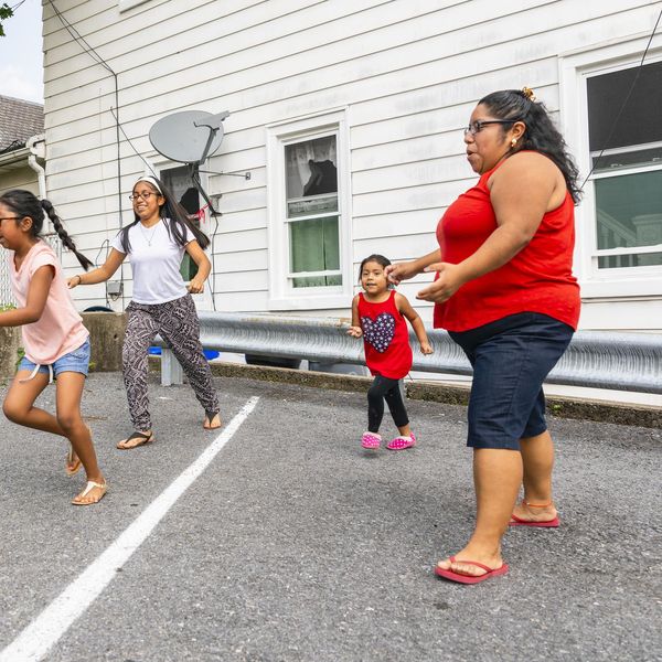 obese mom watching over her Big happy Latino, Mexican-American family