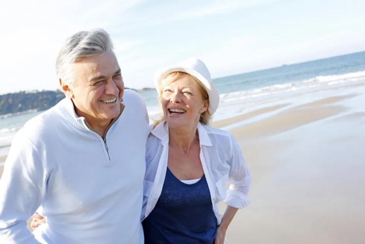 older happy couple on the beach