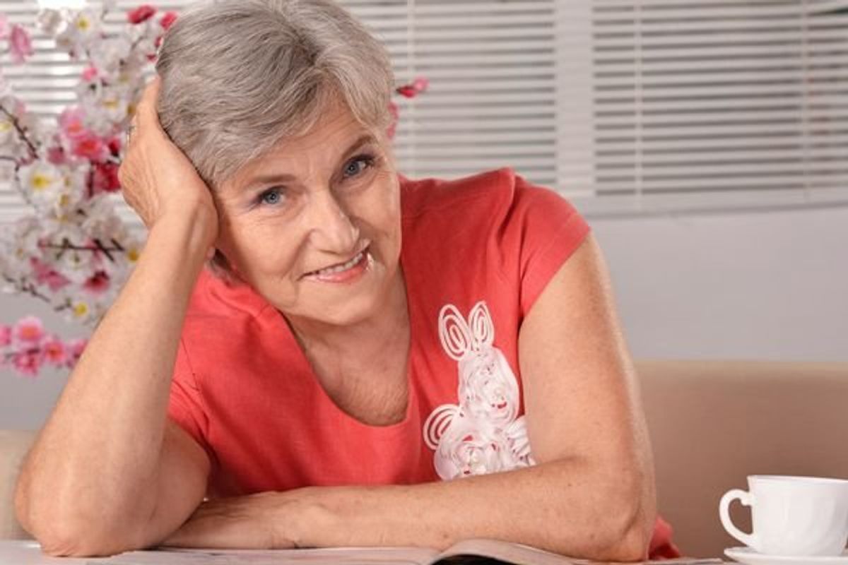 older woman reading a magazine