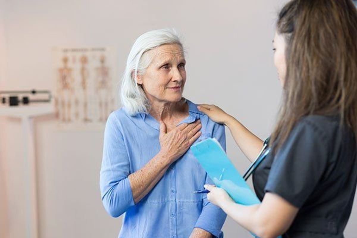 older woman talking to a health professional