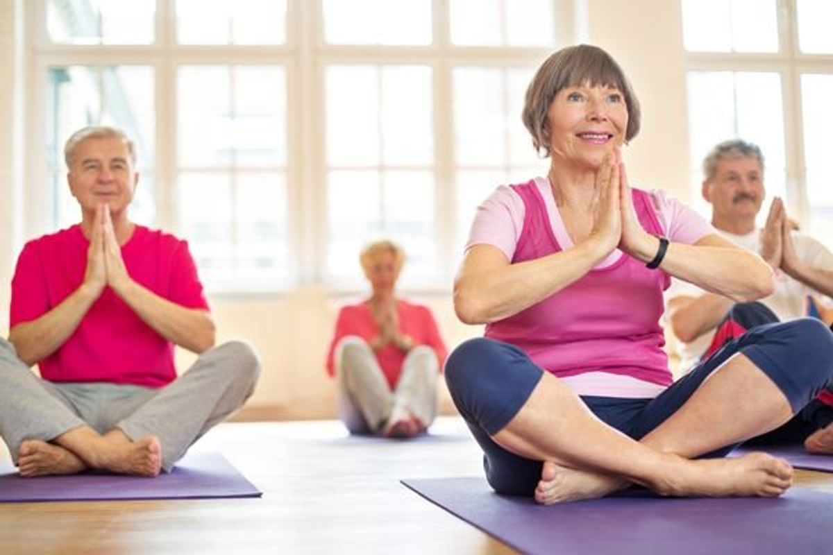 older women practicing yoga