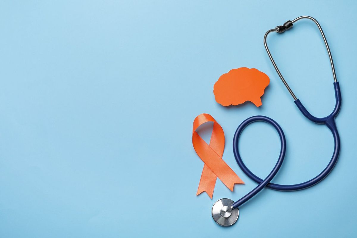 Orange ribbon, stethoscope and paper brain cutout, Multiple sclerosis awareness