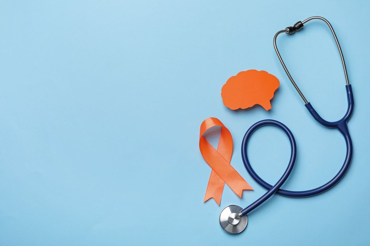 Orange ribbon, stethoscope and paper brain cutout, Multiple sclerosis awareness 