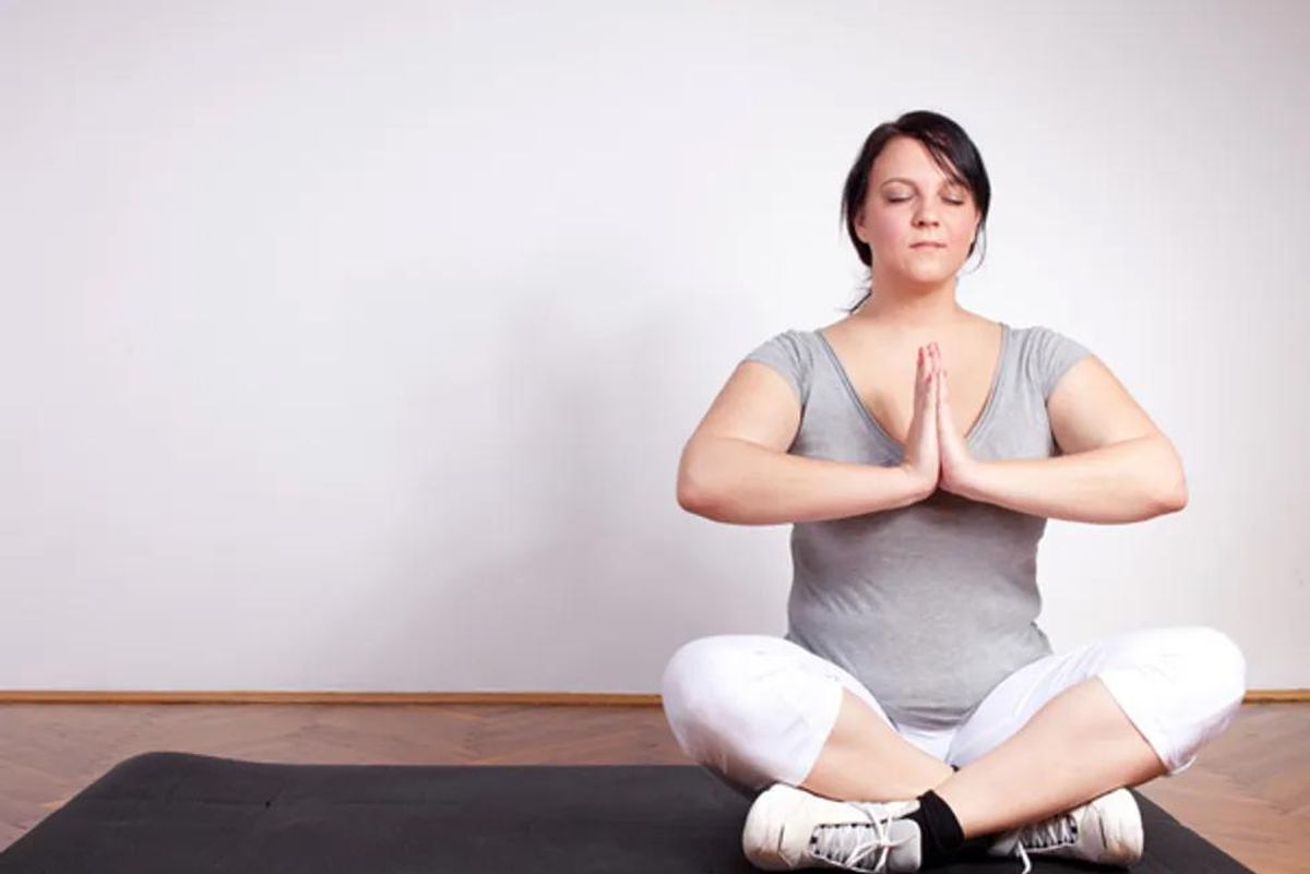 overweight woman practicing yoga