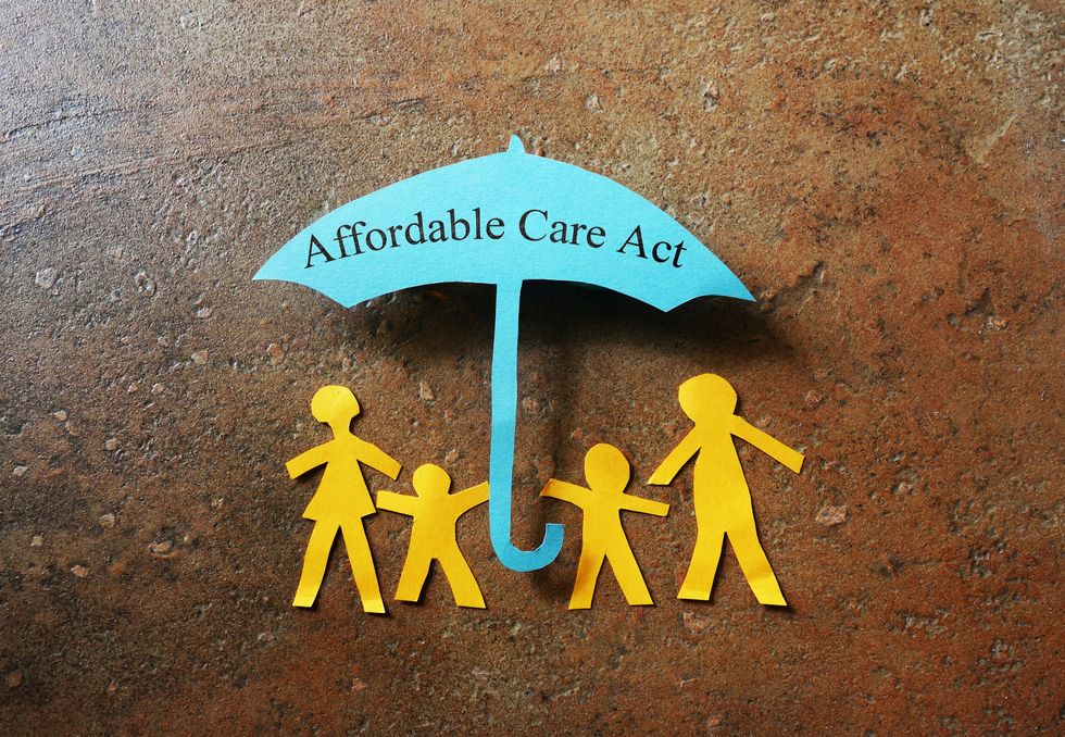 Paper family of four under a Affordable Care Act umbrella