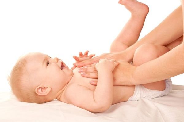 parent massaging baby
