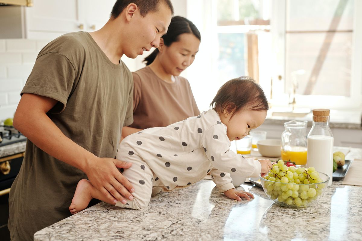 parents and their baby on a kitchen counter