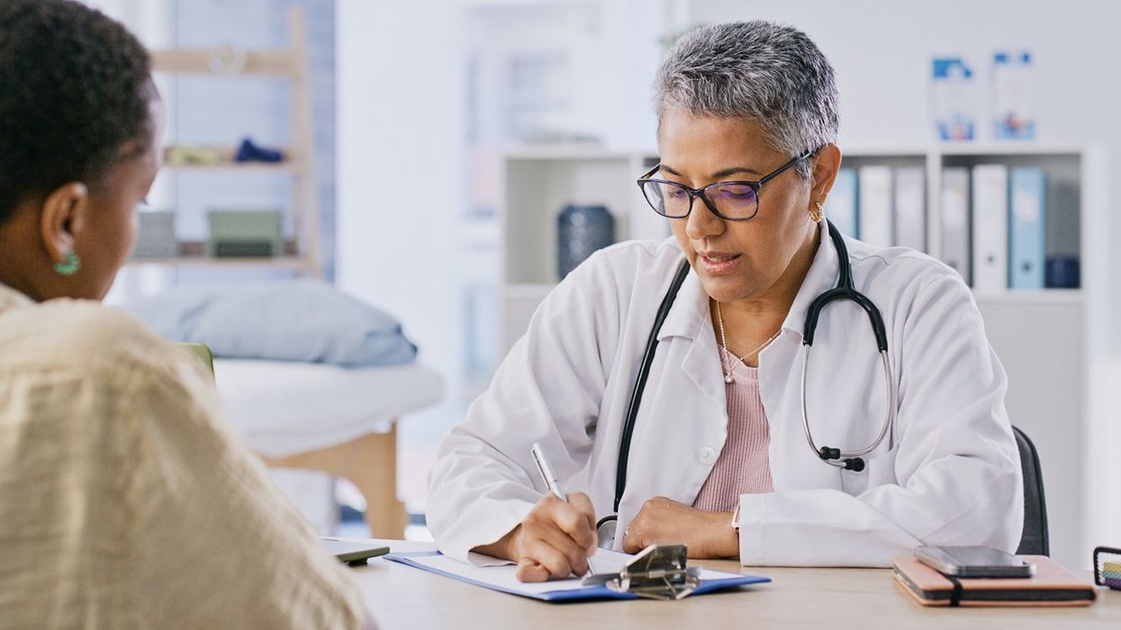 patient and doctor writing in hospital for appointment,