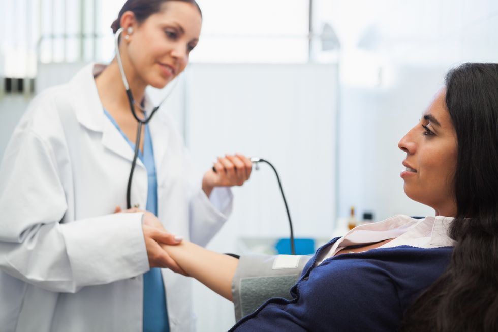 Patients blood pressure being checked by doctor