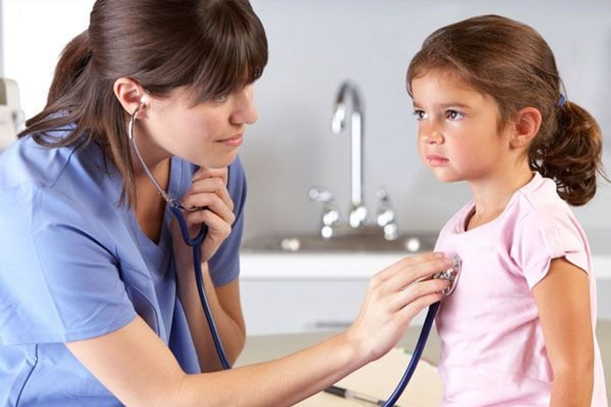 pediatrician listening to childs heart