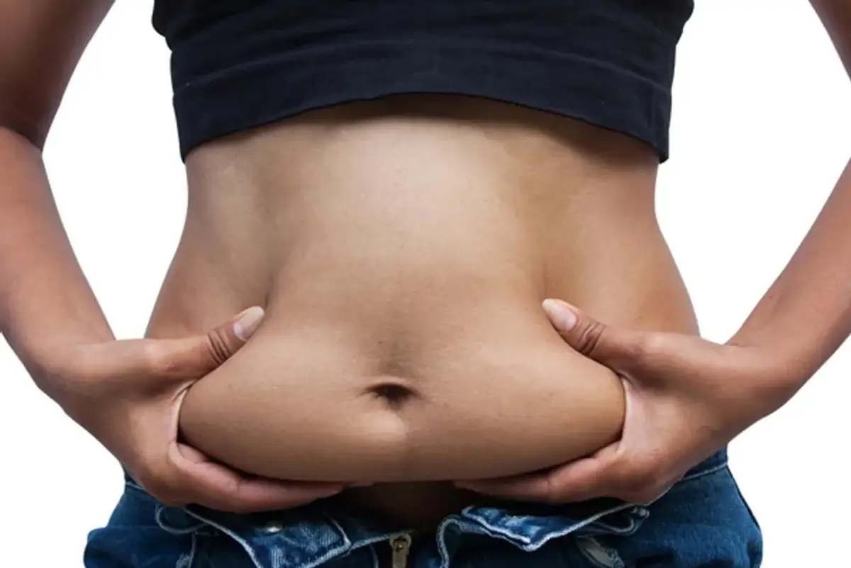 person grabbing their belly fat