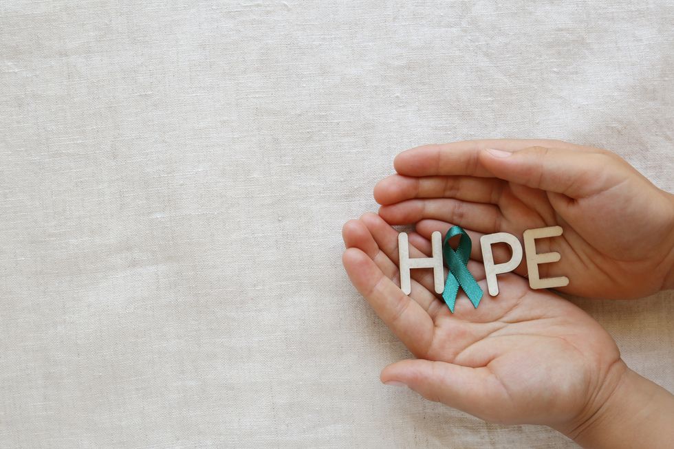 person holding the word HOPE in their hands