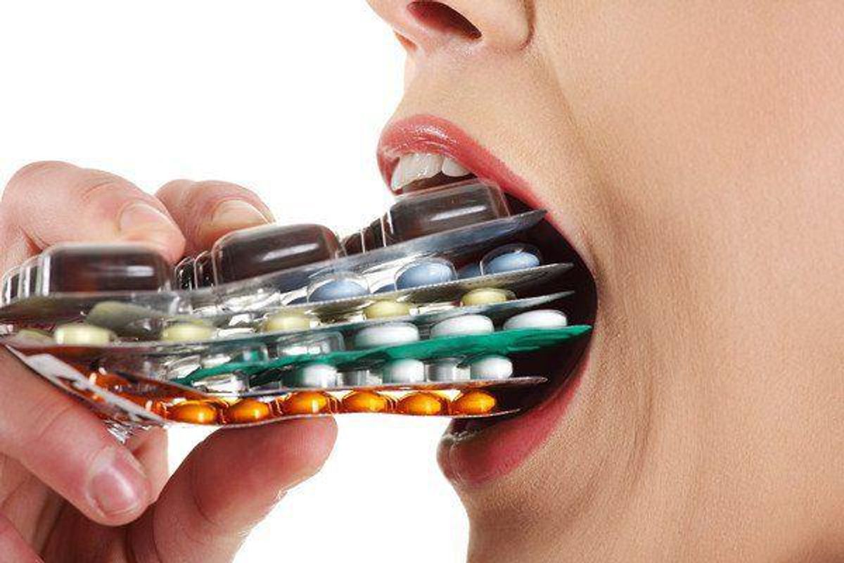 Person putting pill packs in their mouth.