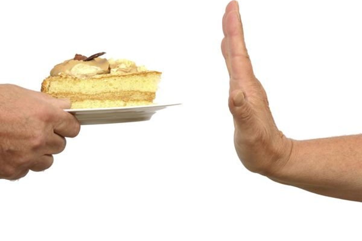 person saying no to cake