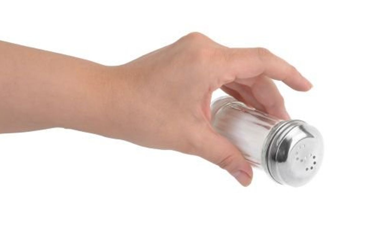 person shaking salt