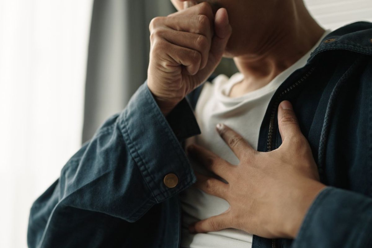 person suffering from painful chest pain from a chronic disease.