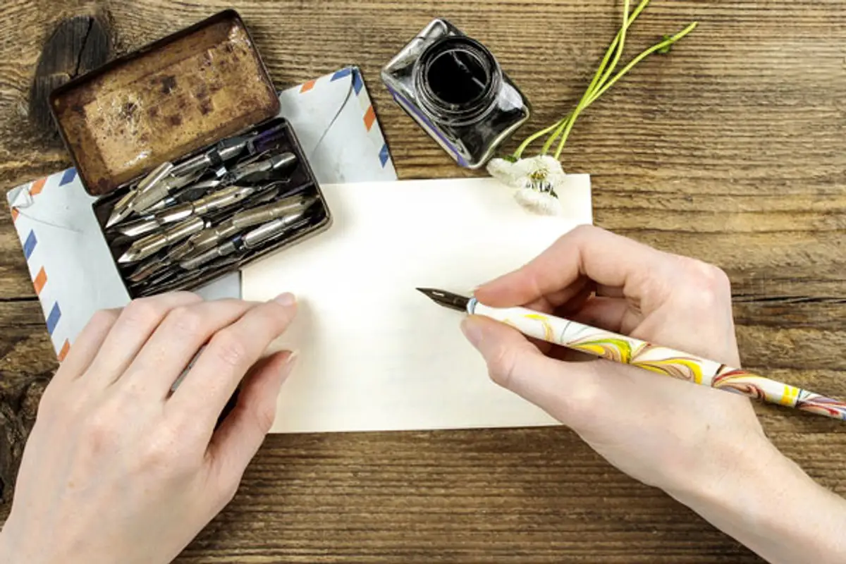 person writing a letter