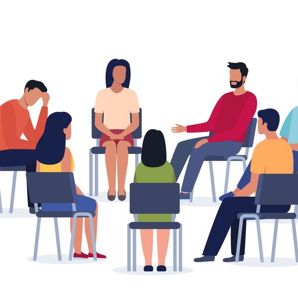 Persons sitting in circle and talking