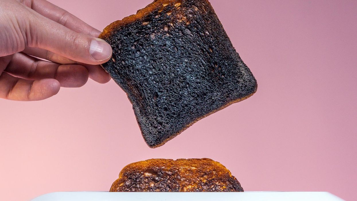 Pieces of burnt bread pop-up from breadtoaster.